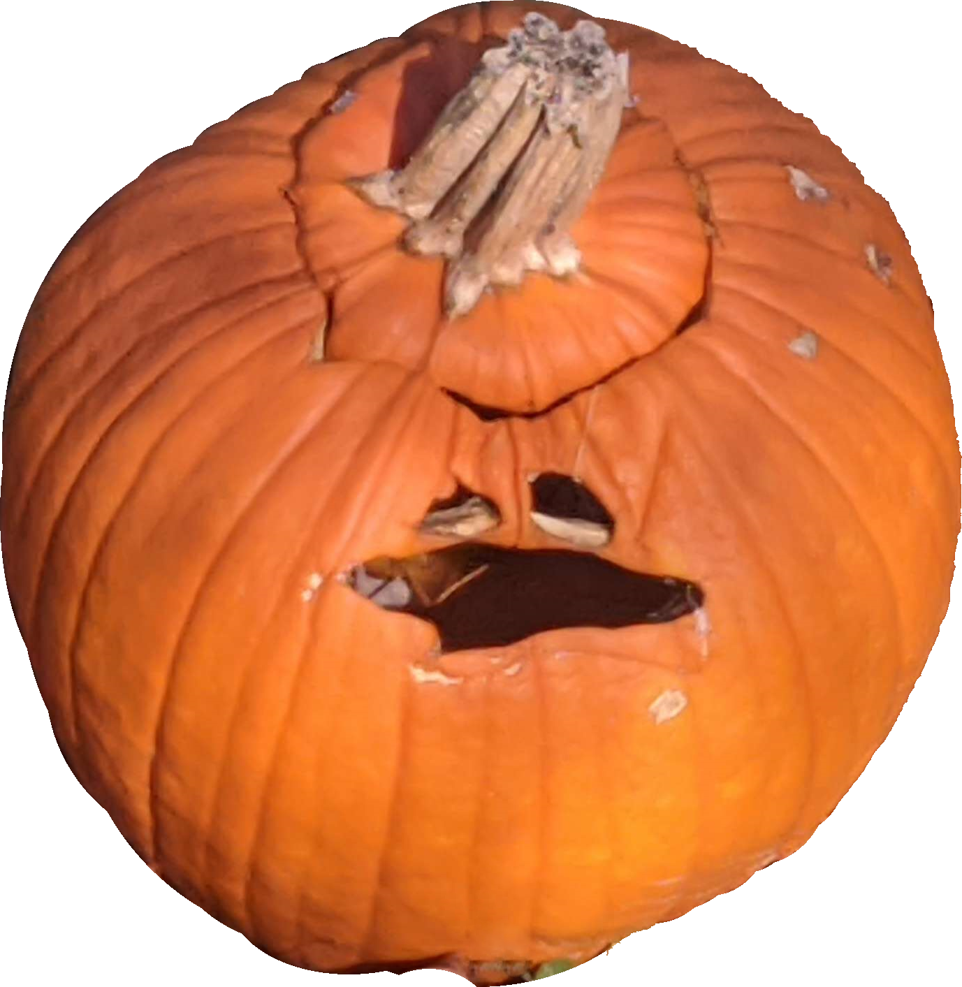 A picture of a partially collapsed Jack o Lantern. The face looks mildly distressed.